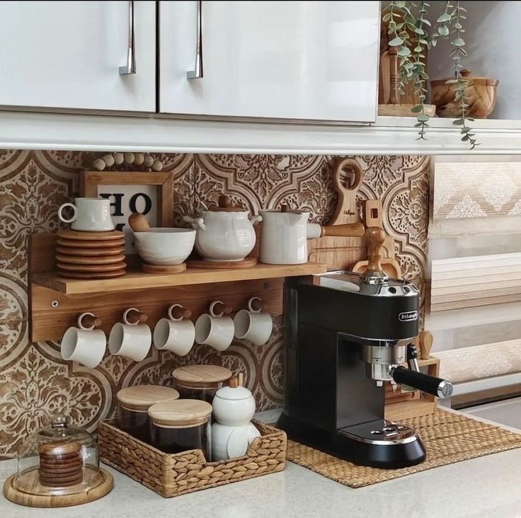 a coffee maker and cups on a shelf in a kitchen