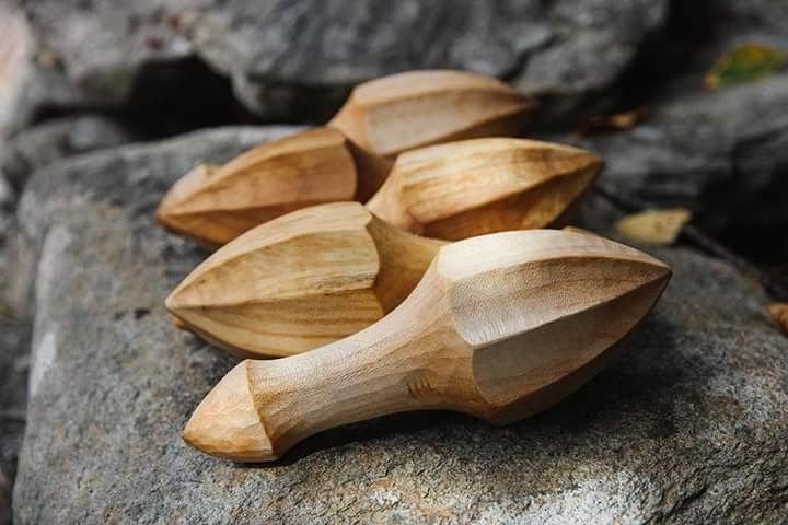 four wooden spoons sitting on top of a rock