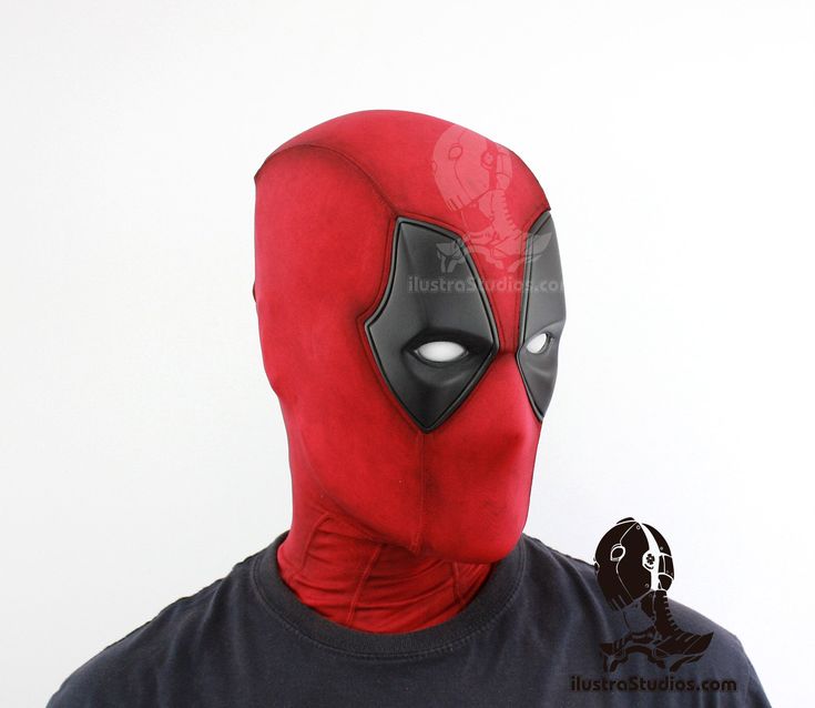 a man wearing a deadpool mask with his face partially covered in black and red