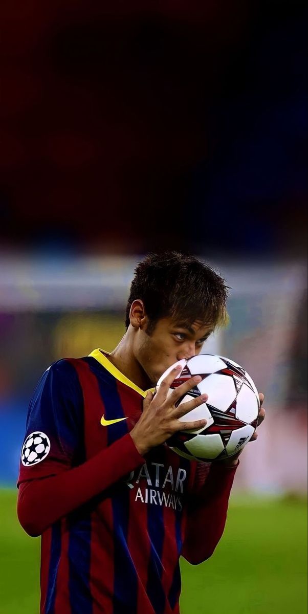 a man holding a soccer ball in his hands