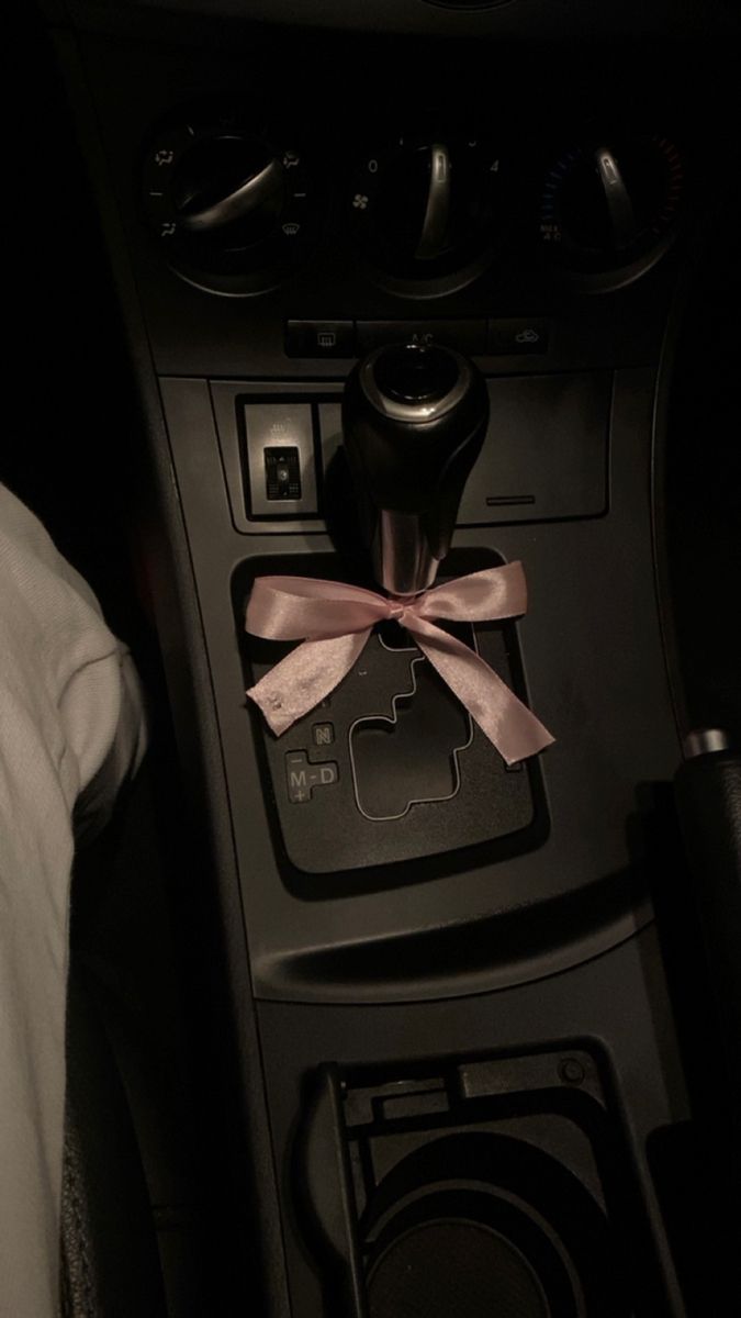 the interior of a car with a steering wheel and an air freshener attached to it