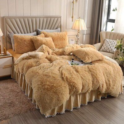 the bed is made with fluffy fur and pillows