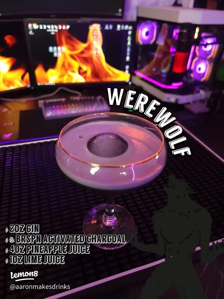 a close up of a glass on a table with fire in the background and text overlay that reads, werwolfe