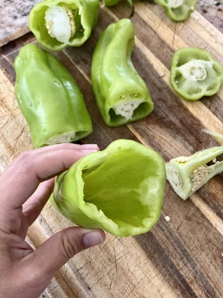 someone is holding up some food on a cutting board