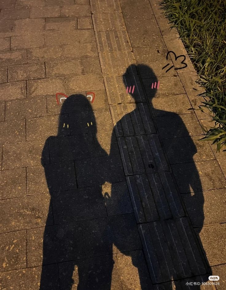 the shadow of two people standing next to each other