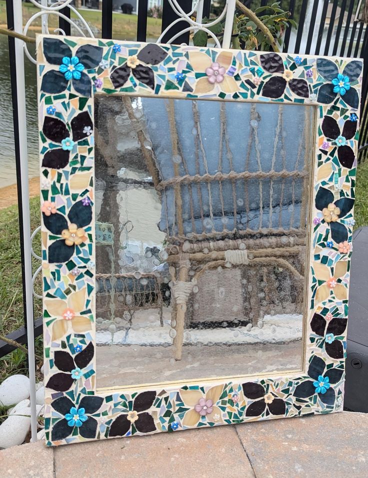 a decorative mirror sitting on top of a sidewalk