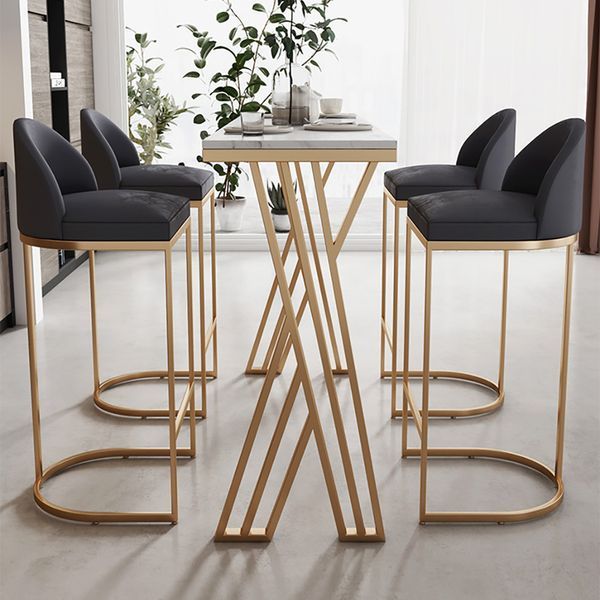 a table with four chairs and a vase on it