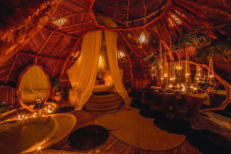 the inside of a hut with candles lit up