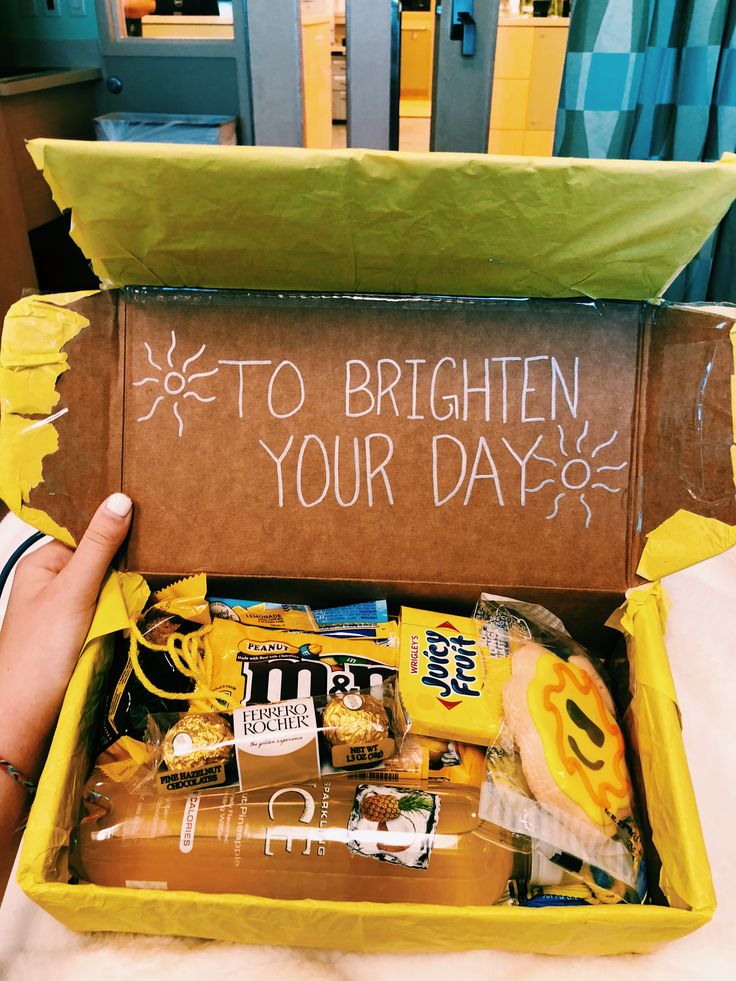 someone is holding up a box with some food in it that says to brighten your day