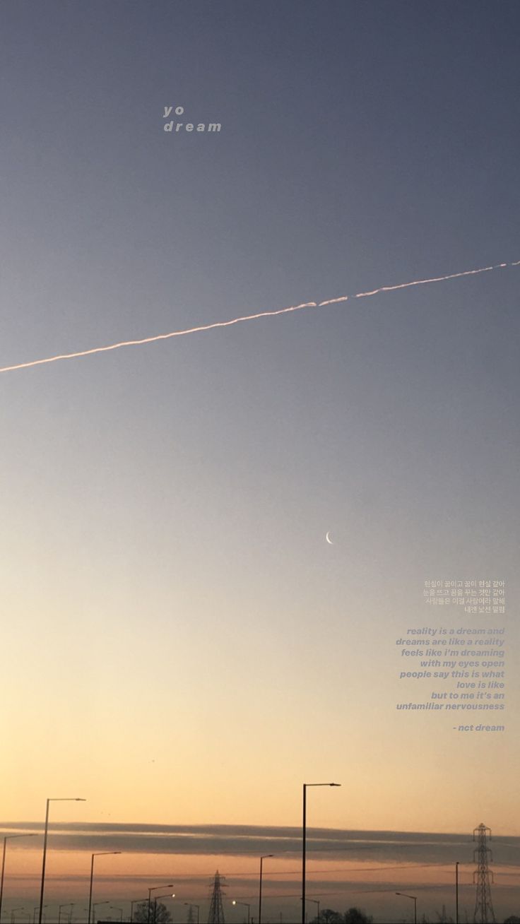 an airplane is flying in the sky at sunset