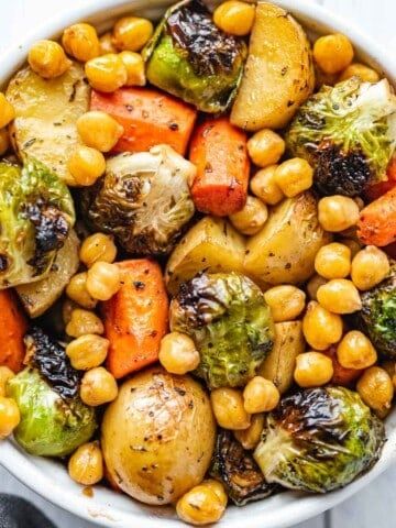 a white bowl filled with vegetables and chickpeas