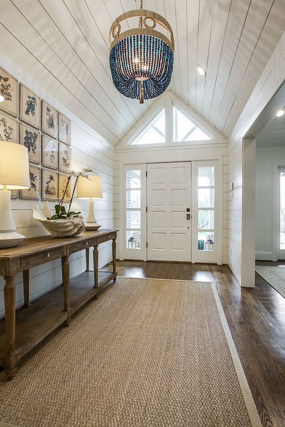 the inside of a house with pictures on the wall and ceiling, including a chandelier