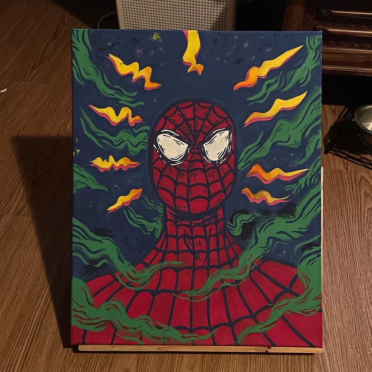 a painting of a spider man on a wooden table