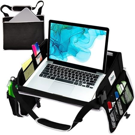 an open laptop computer sitting on top of a bag