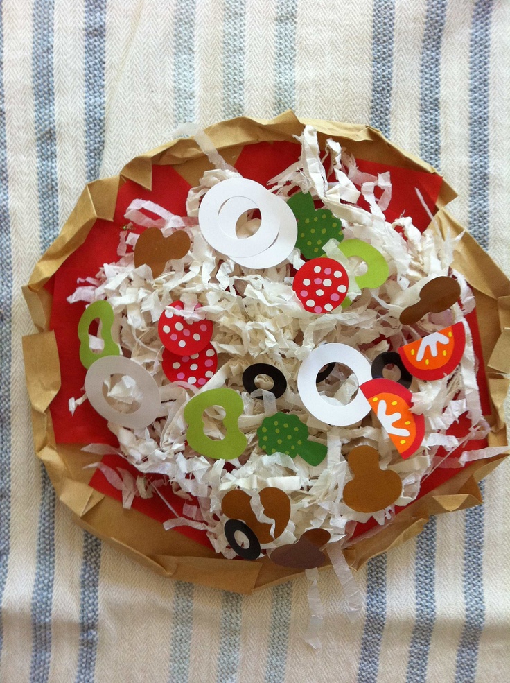 a paper plate filled with assorted donuts on top of a striped table cloth