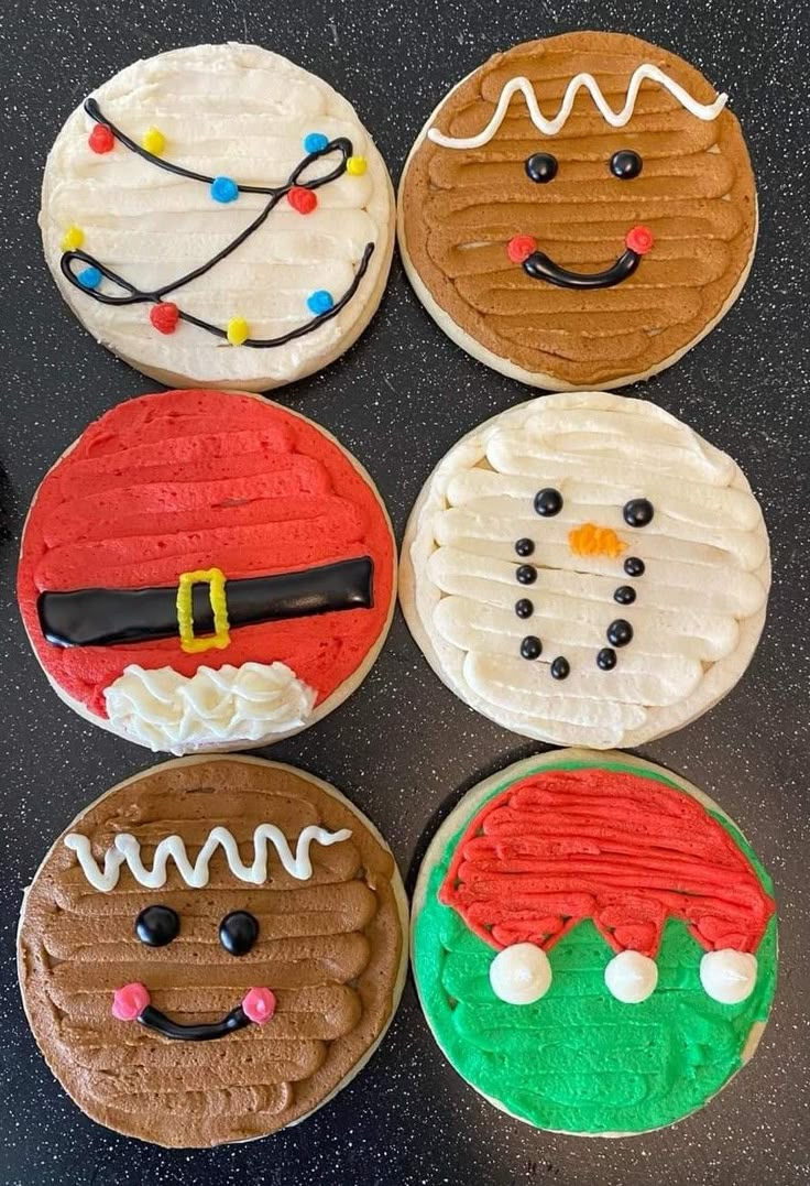 six decorated cookies sitting on top of a counter