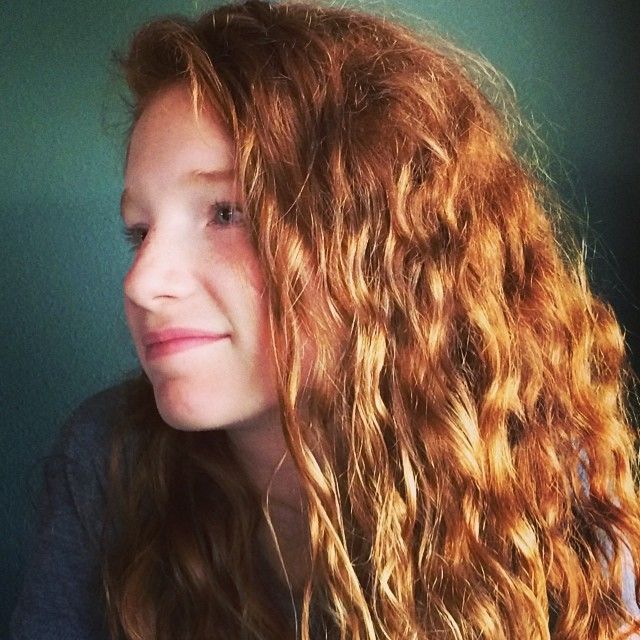 a close up of a person with long curly hair