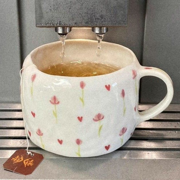 a cup filled with liquid sitting on top of a counter