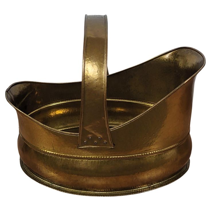 a gold colored metal container with two handles and one handle on the top, sitting in front of a white background