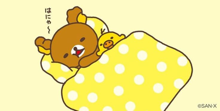 a brown teddy bear sleeping on top of a yellow polka dot covered blanket with an emoticive message above it