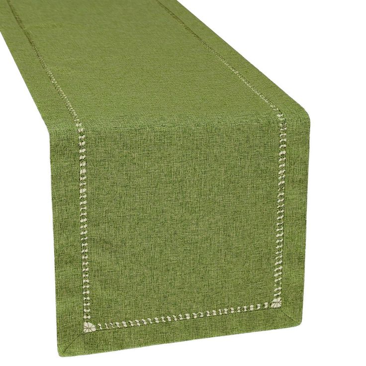 a green table runner with white stitching