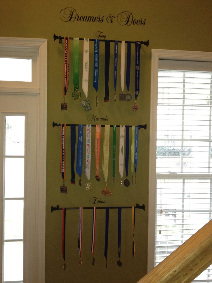 a wall mounted medal rack with medals on it