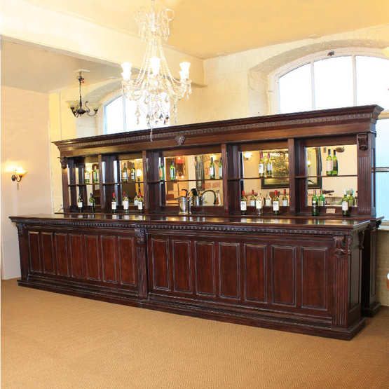 a large wooden bar with lots of bottles on it