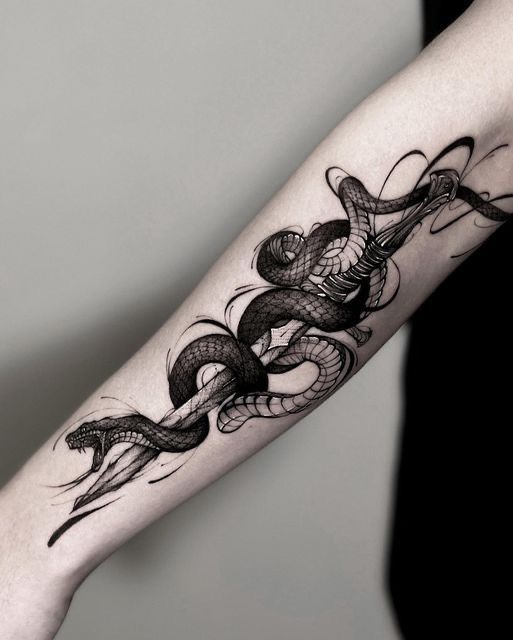 a woman's arm with a snake tattoo on it