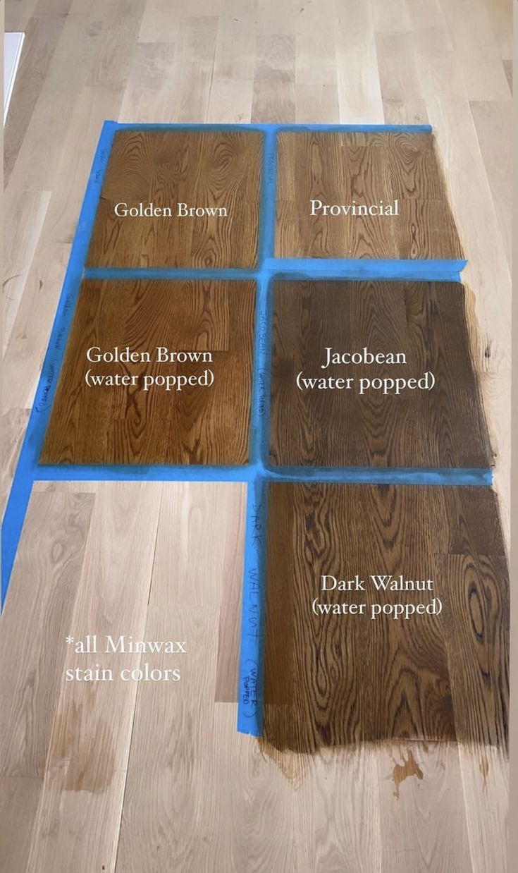 the floor is being laid out with different types of wood on it and labeled in blue tape