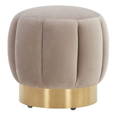 a round stool with gold accents on the legs and footrests, in grey velvet