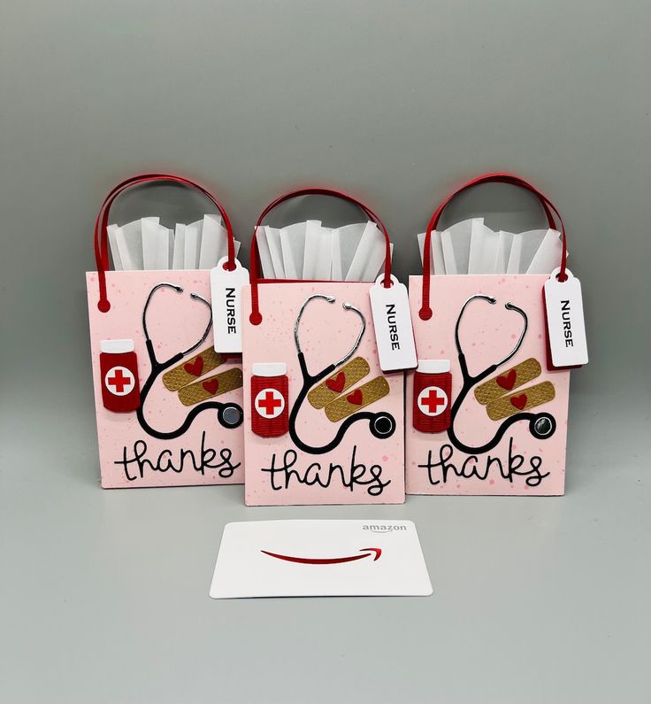 three pink bags with red handles and stethoscopes on them that say thank thanks