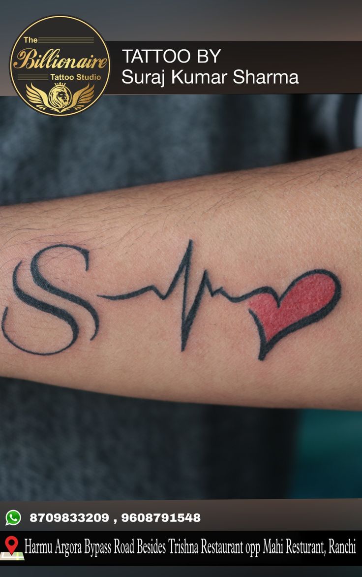 a tattoo with a heart and heartbeat on the arm