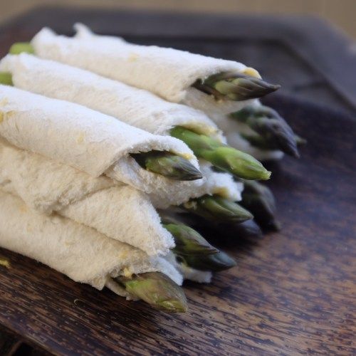 asparagus wrapped in flour on a cutting board