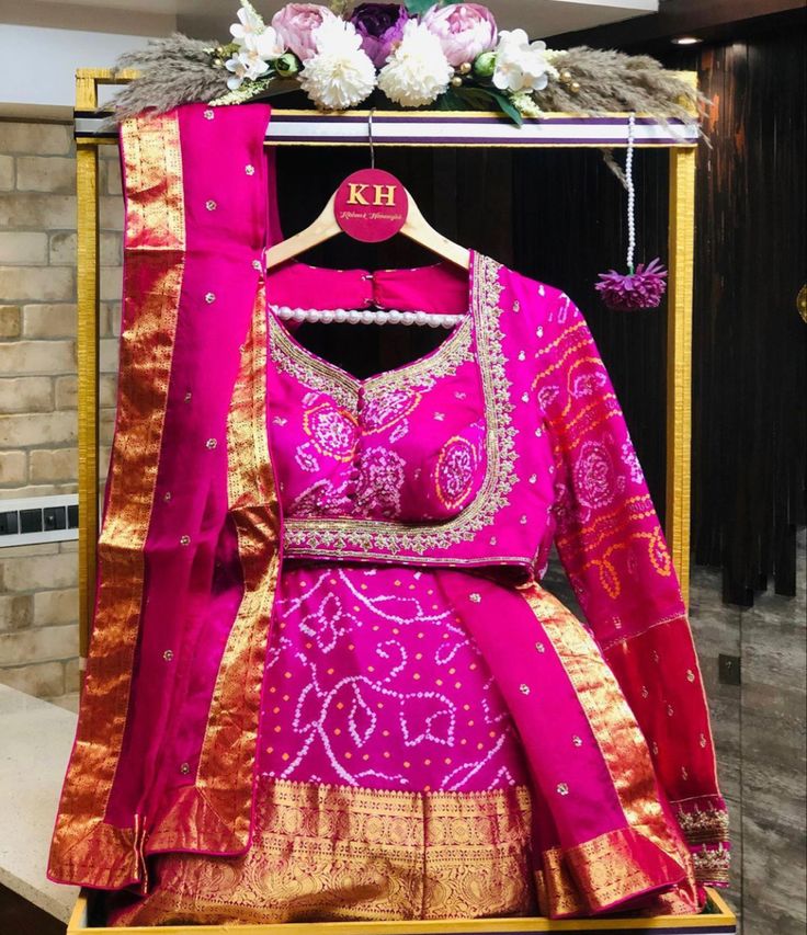 a pink and gold lehenga on display