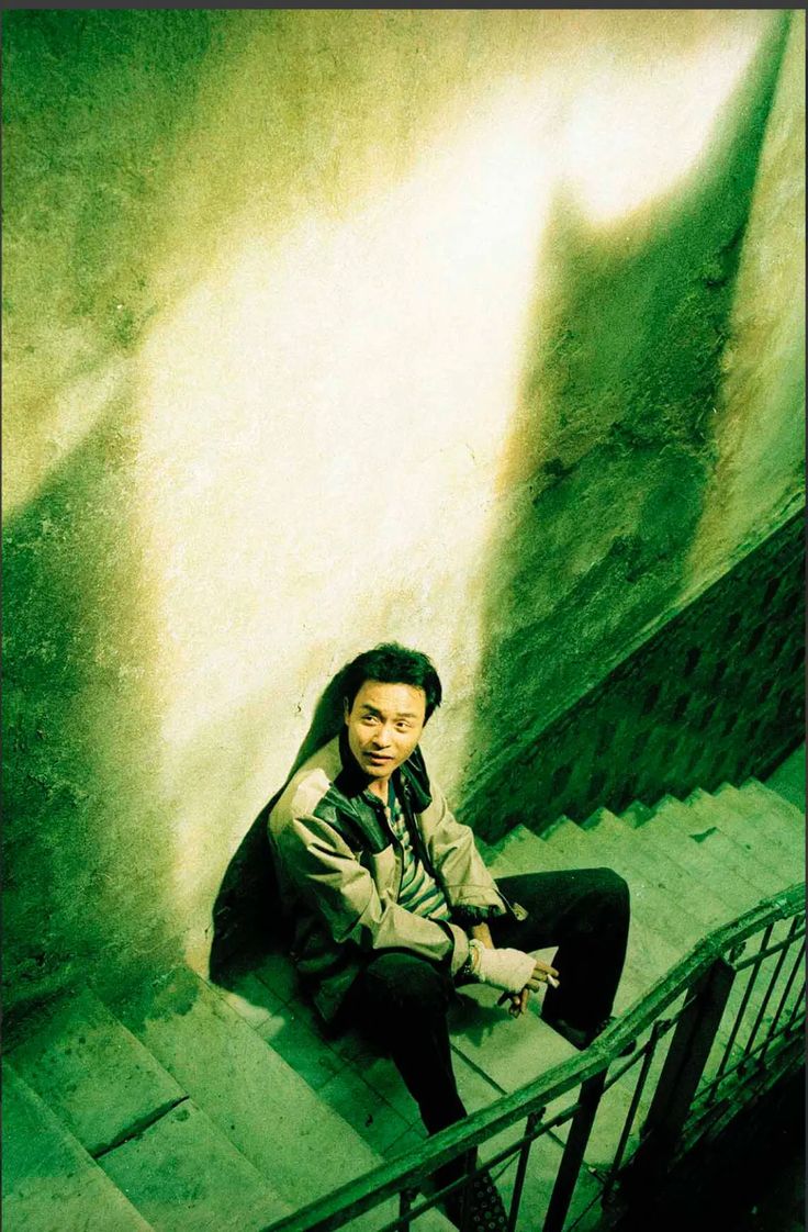 a man sitting on top of a set of stairs