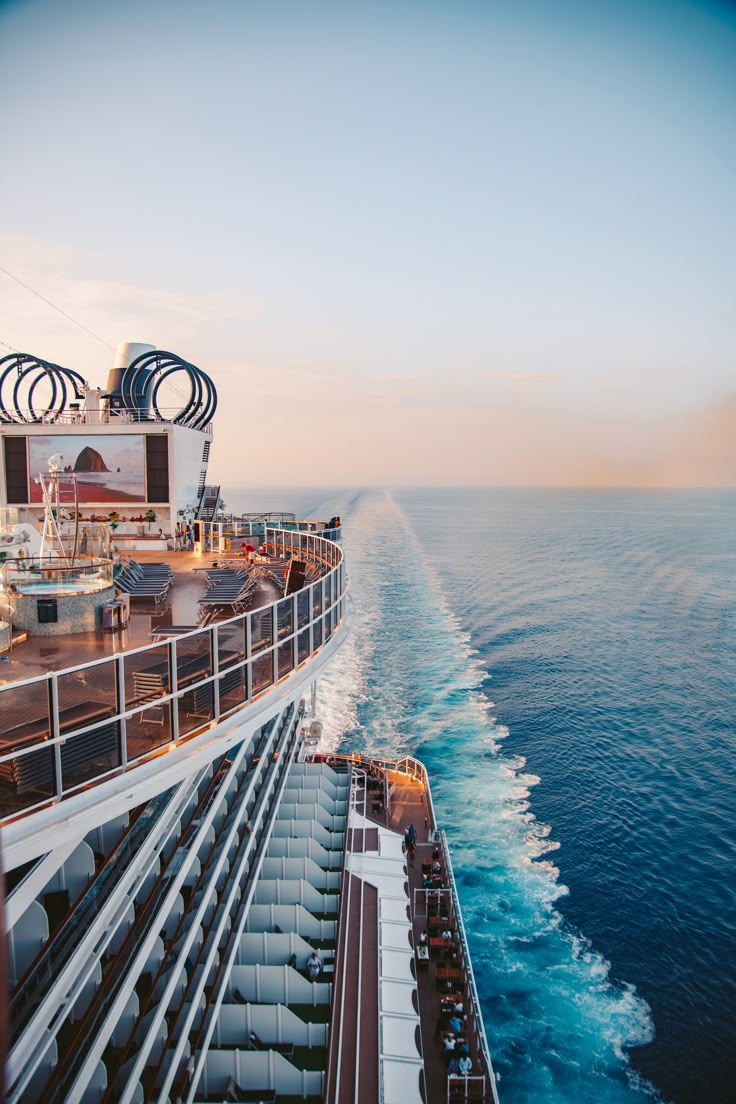 the top deck of a cruise ship as it travels through the ocean at sunset or dawn