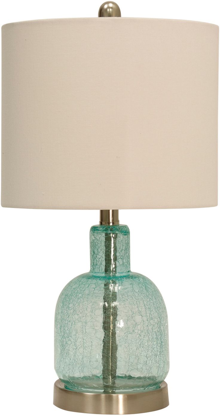 a green glass table lamp with a white shade