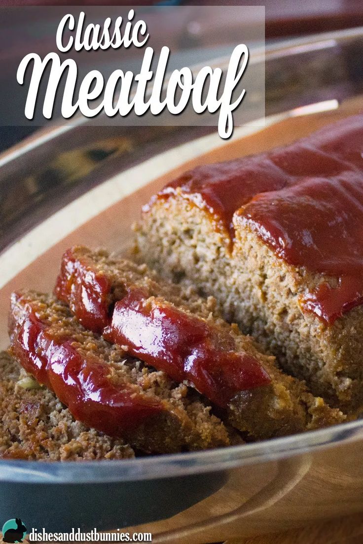 meatloaf with ketchup in a glass bowl on a wooden table and text overlay reading classic meatloaf