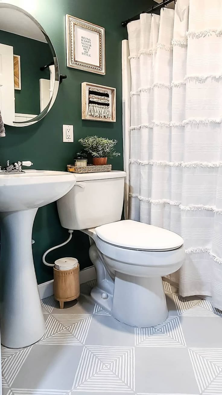 a white toilet sitting next to a sink in a bathroom under a mirror on the wall