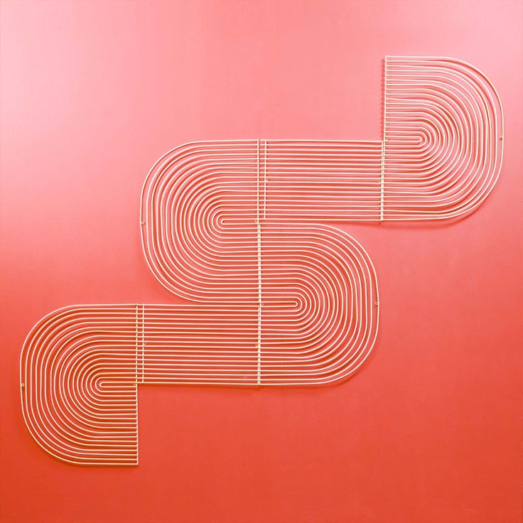 two pieces of metal on a red surface with lines in the shape of letters and numbers