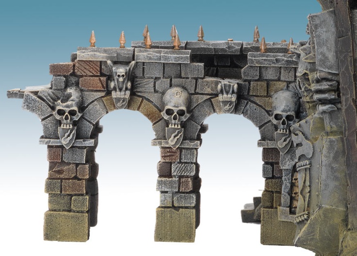 a stone arch with skulls and bones on it