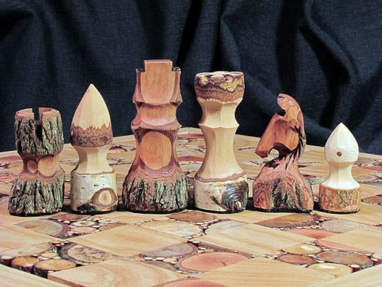 a wooden chess board with several pieces on it