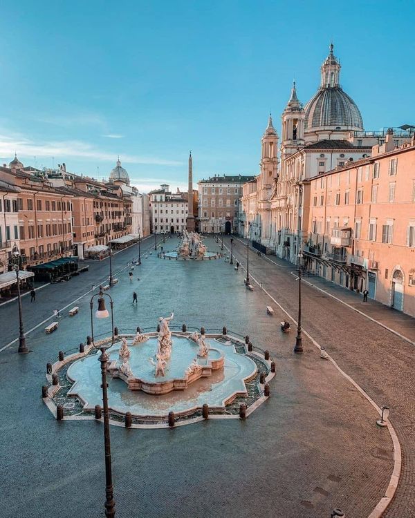 an aerial view of a fountain in the middle of a street