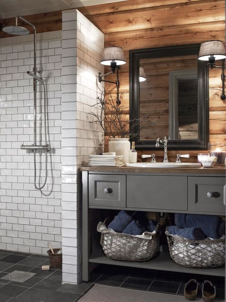 a bathroom with a sink, mirror and shower stall in it's center area