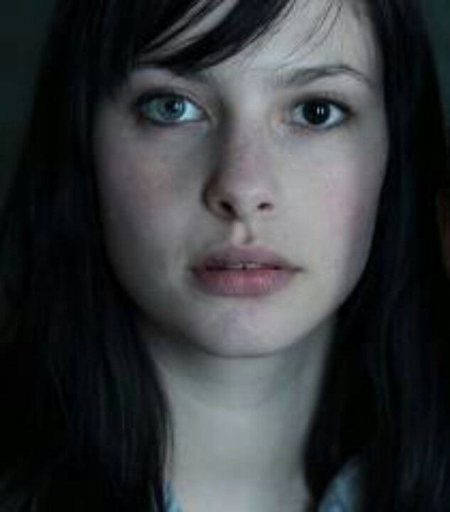 a woman with long black hair and blue eyes