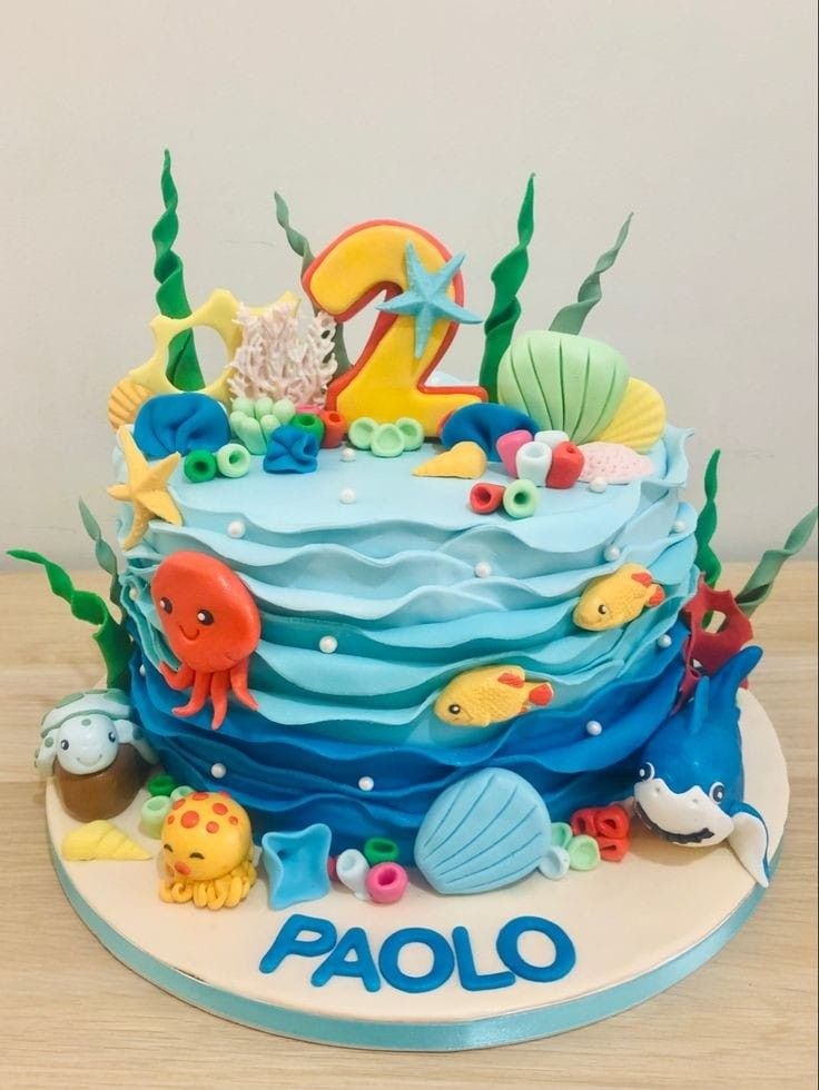 a birthday cake decorated with an ocean theme