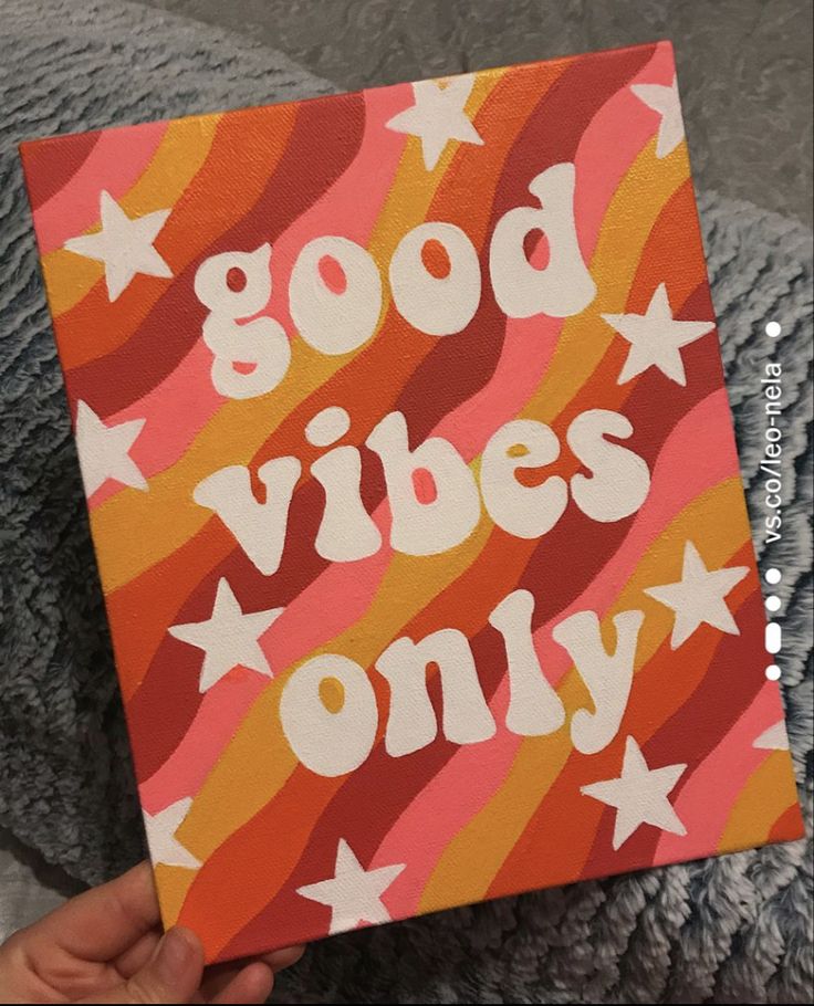 someone is holding up a book that says good vibes only