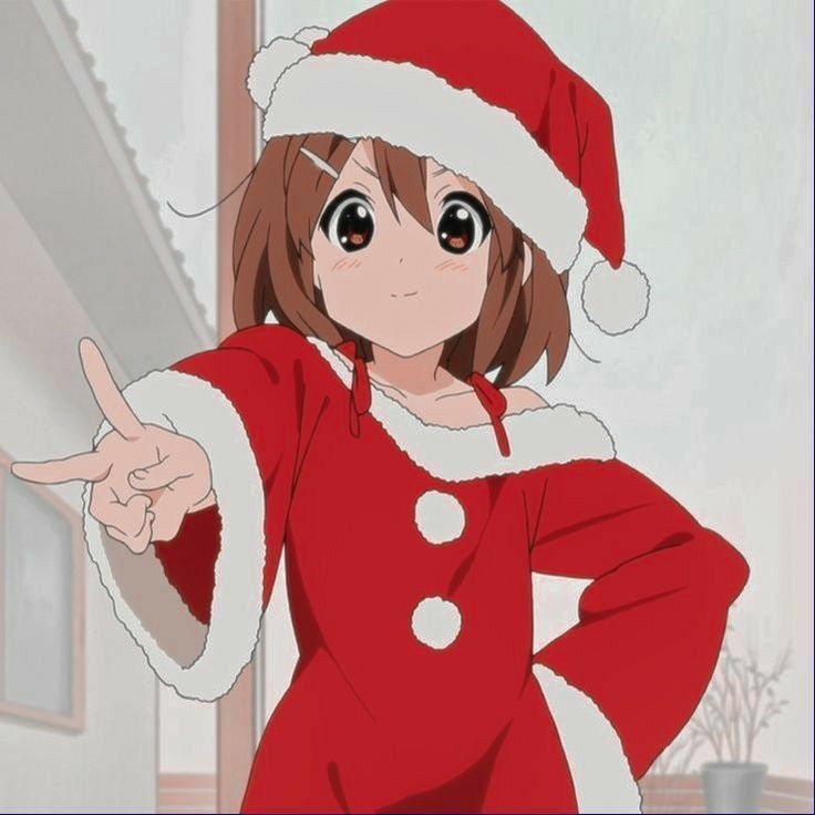 a woman in a santa hat pointing at something