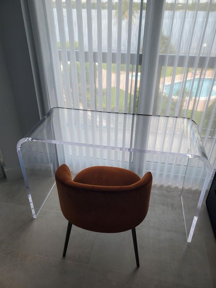 an orange chair sitting in front of a window