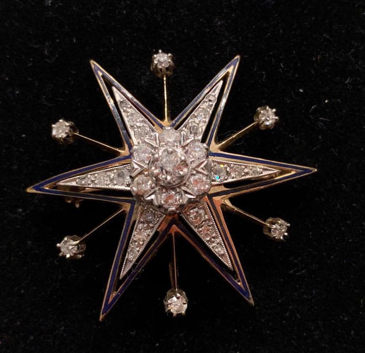 an antique star brooch with diamonds on it